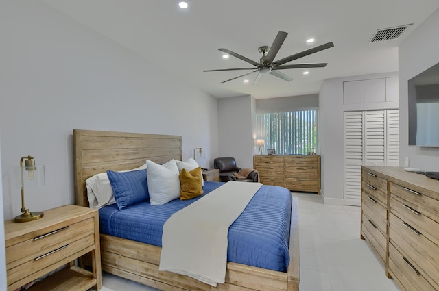 bedroom with a closet, ceiling fan, and light tile floors