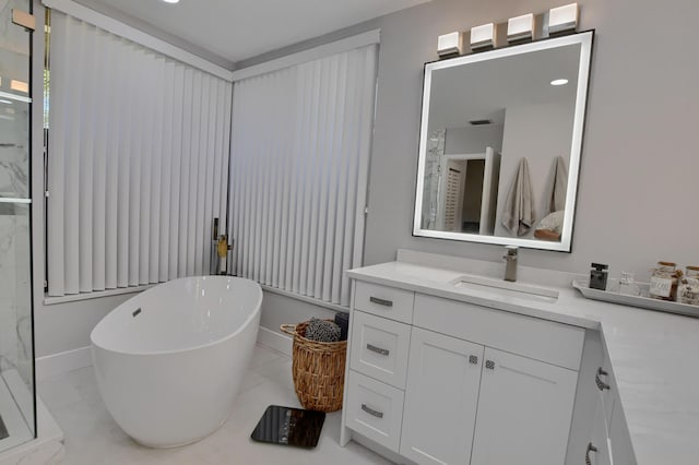 bathroom with tile flooring, vanity, and a tub