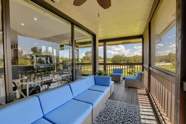 sunroom / solarium featuring ceiling fan