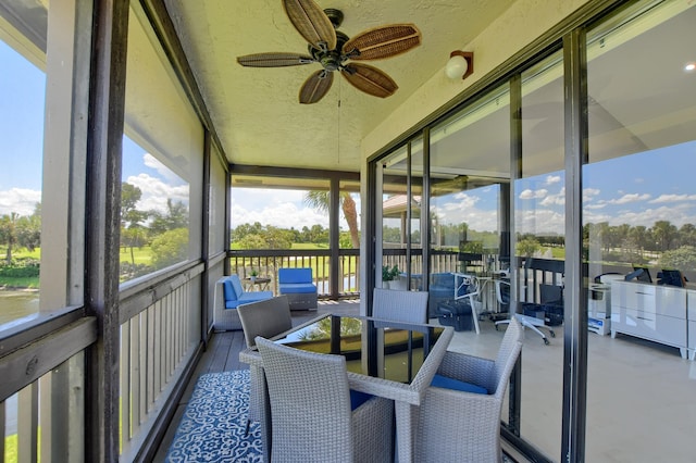 sunroom / solarium featuring ceiling fan