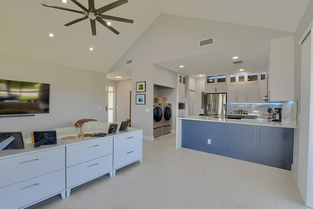 kitchen with white cabinets, light tile floors, independent washer and dryer, and ceiling fan