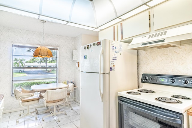 kitchen with custom range hood, white appliances, light tile flooring, and white cabinets