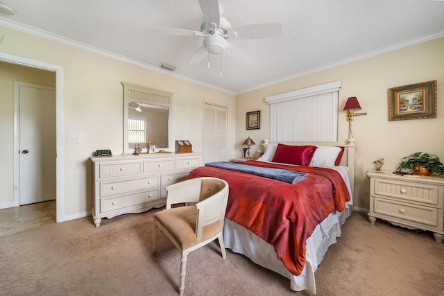 carpeted bedroom featuring crown molding, a closet, and ceiling fan