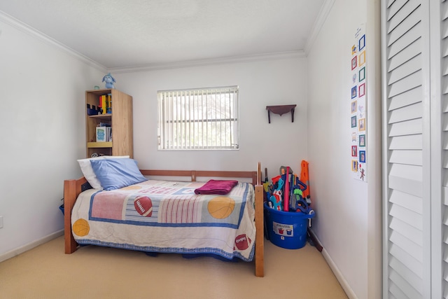 bedroom with ornamental molding and carpet