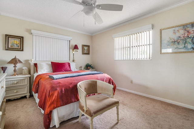 carpeted bedroom featuring crown molding and ceiling fan