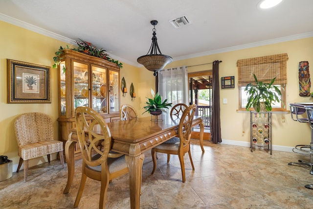 dining space featuring crown molding and light tile floors