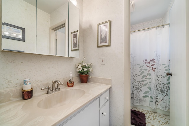 bathroom featuring vanity with extensive cabinet space