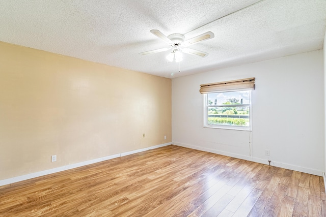 empty room featuring light hardwood / wood-style flooring, ceiling fan, and a textured ceiling