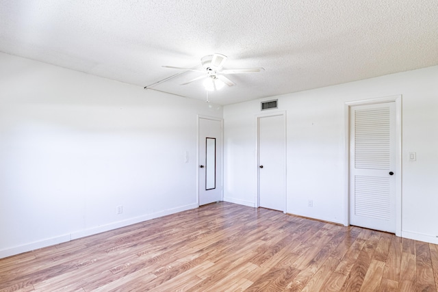 unfurnished bedroom with a textured ceiling, ceiling fan, and light wood-type flooring