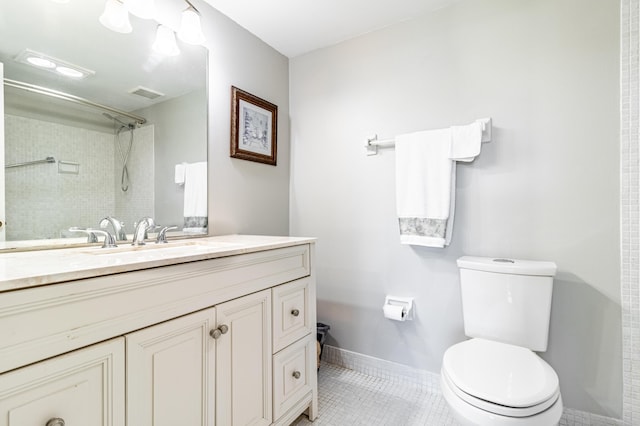 bathroom with tile floors, toilet, and vanity