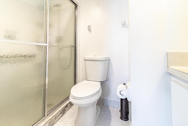 bathroom with toilet, tile flooring, an enclosed shower, and vanity