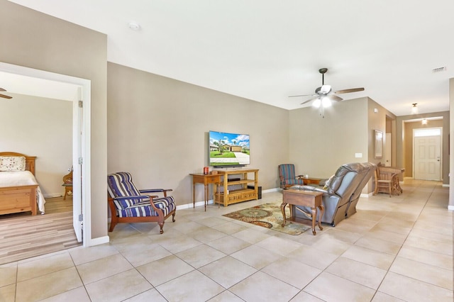 tiled living room with ceiling fan