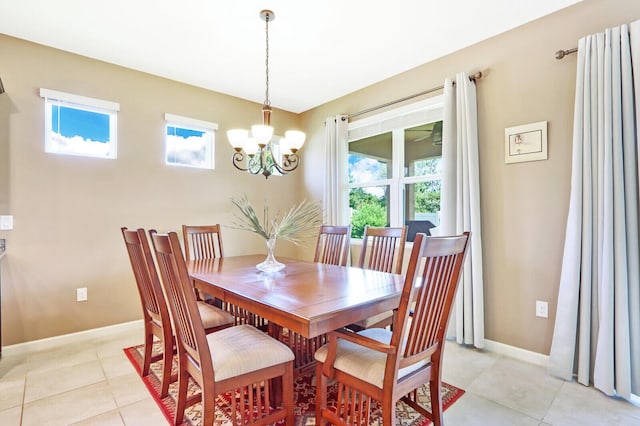 tiled dining space with a chandelier