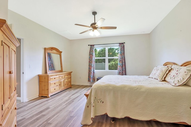 bedroom with ceiling fan and light hardwood / wood-style flooring