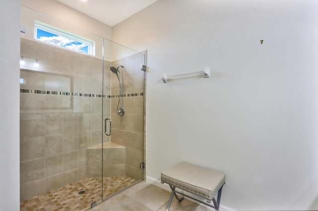 bathroom with an enclosed shower and tile floors