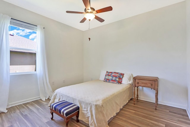 bedroom with wood-type flooring and ceiling fan