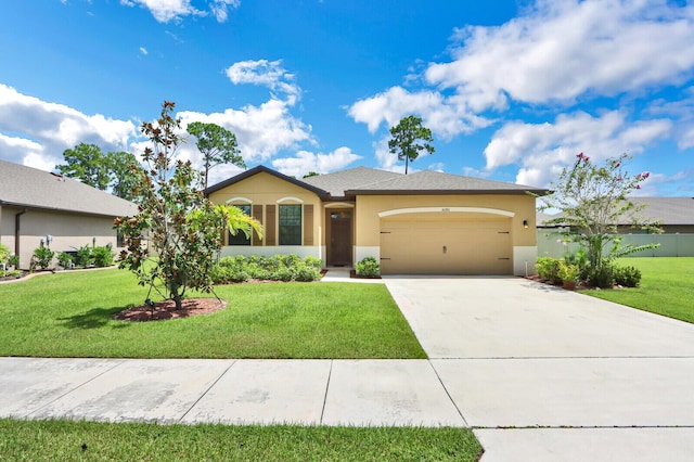 view of front of home featuring a front yard and a garage