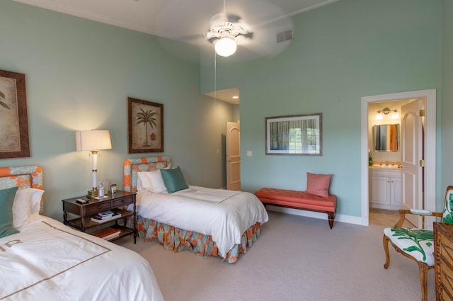 bedroom with carpet, a high ceiling, ensuite bath, and ceiling fan