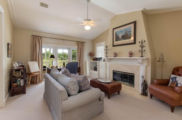 living room with light colored carpet, a high end fireplace, ornamental molding, and ceiling fan