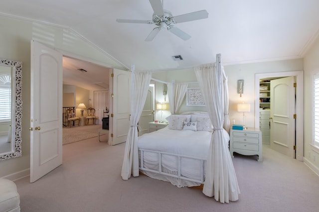 carpeted bedroom featuring crown molding, vaulted ceiling, and ceiling fan