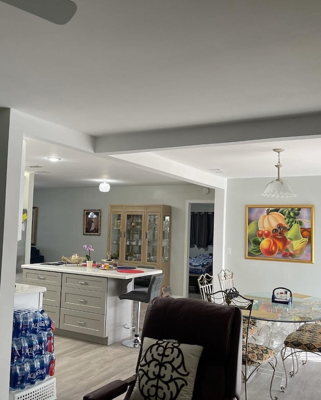 interior space featuring beam ceiling and light hardwood / wood-style floors