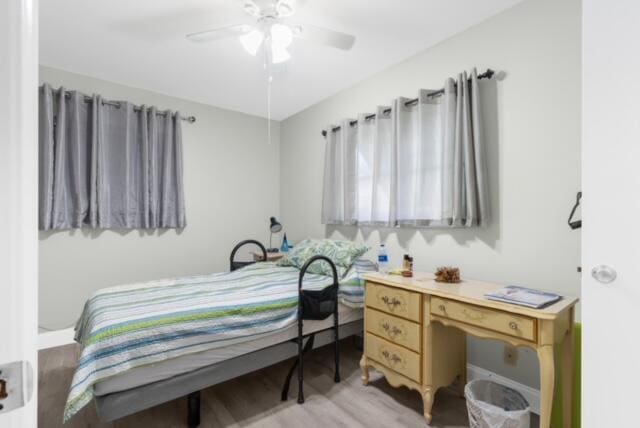 bedroom with ceiling fan and light wood-type flooring