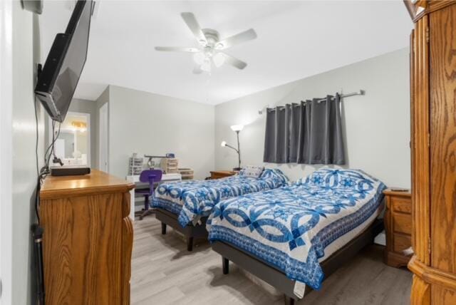 bedroom with light hardwood / wood-style floors and ceiling fan