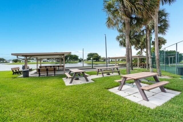 surrounding community featuring a water view and a yard