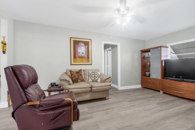 living room featuring ceiling fan and light wood-type flooring