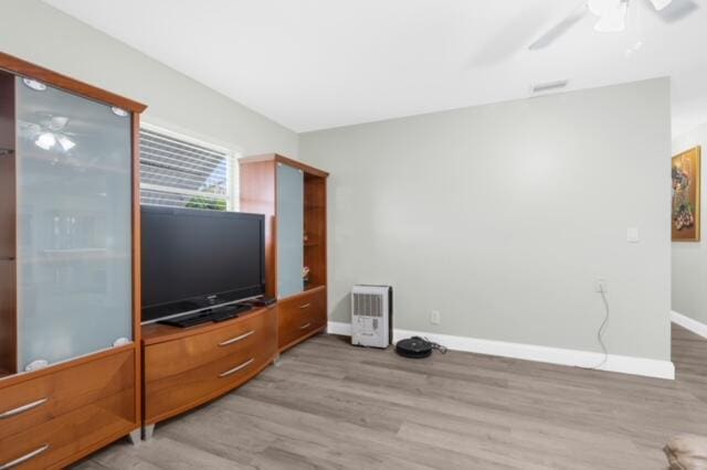 living room featuring ceiling fan and light wood-type flooring