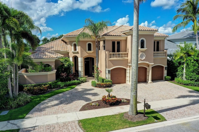 mediterranean / spanish home featuring a balcony and a garage