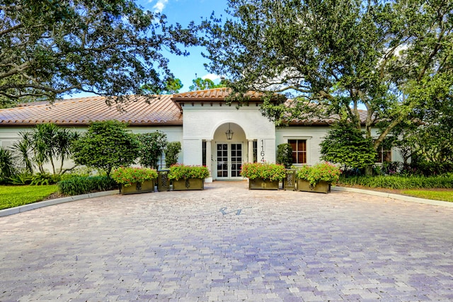 mediterranean / spanish-style house with french doors