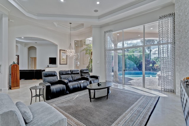 tiled living room featuring ornamental molding, a chandelier, and a tray ceiling