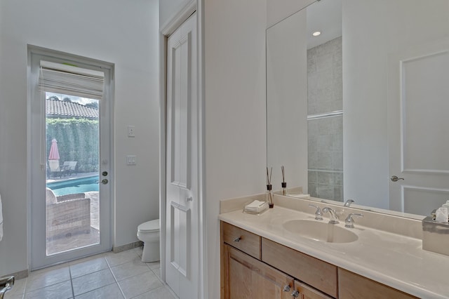 bathroom with tile floors, toilet, and oversized vanity