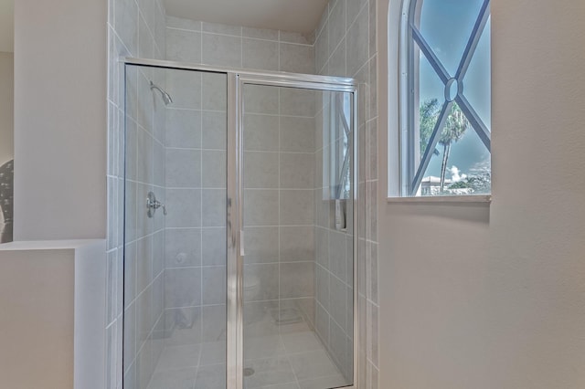 bathroom with a shower with door