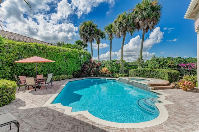 view of pool featuring an in ground hot tub and a patio