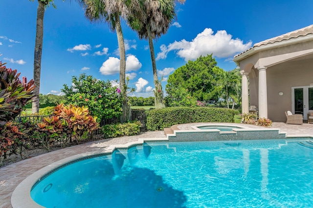 view of swimming pool with a patio and an in ground hot tub