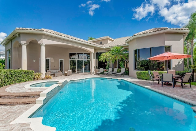 view of pool with an in ground hot tub and a patio area