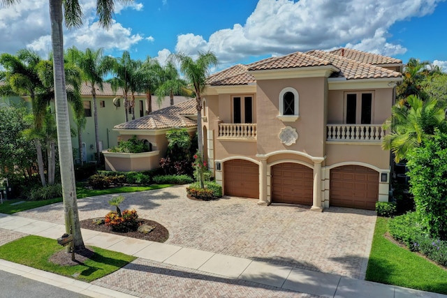 mediterranean / spanish home with a balcony and a garage