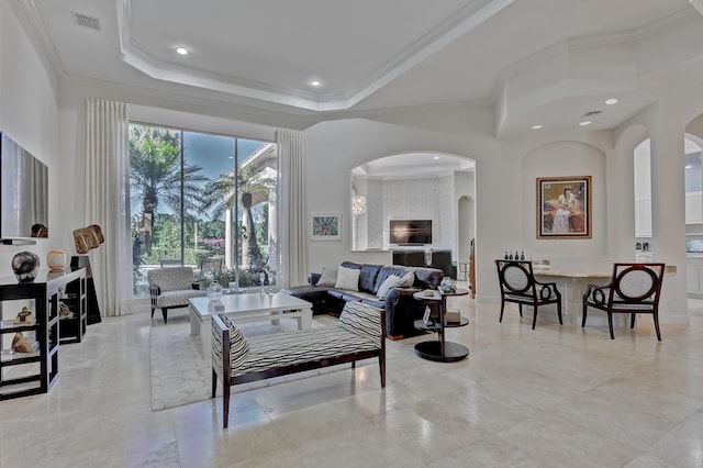 tiled living room featuring crown molding and a raised ceiling