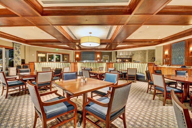 carpeted dining area with coffered ceiling, crown molding, and beam ceiling