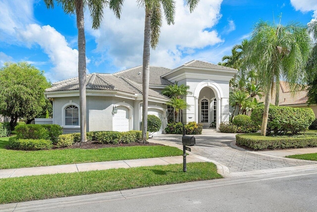 mediterranean / spanish-style home with a garage