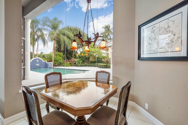 tiled dining area featuring a healthy amount of sunlight