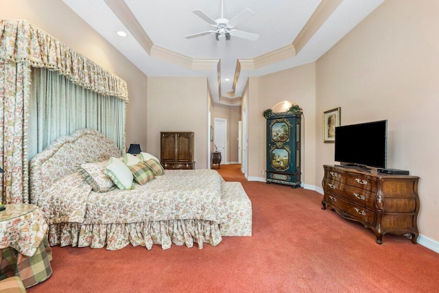 carpeted bedroom featuring ceiling fan, crown molding, and a raised ceiling