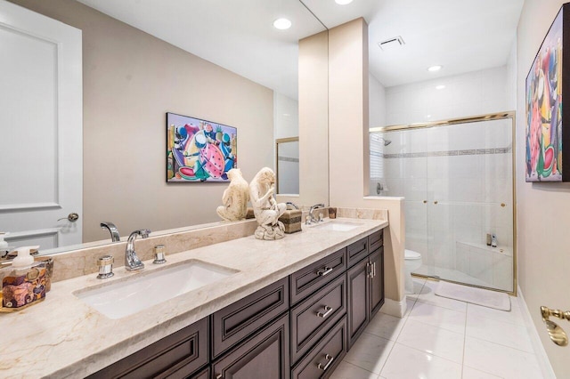 bathroom featuring toilet, double vanity, and tile floors