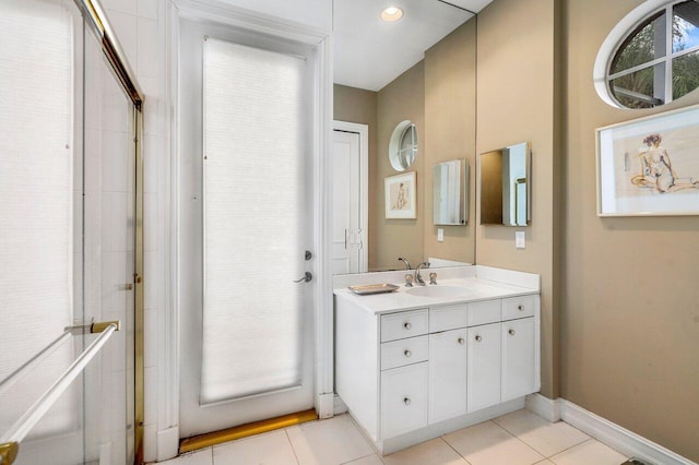 bathroom with tile flooring, a shower with shower door, and vanity