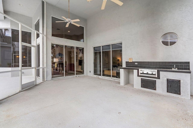 view of patio / terrace featuring exterior kitchen and ceiling fan