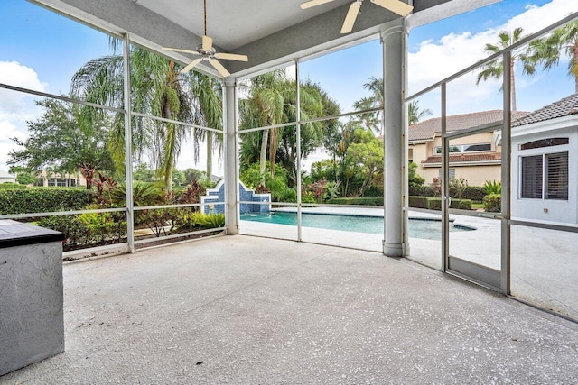 unfurnished sunroom featuring ceiling fan