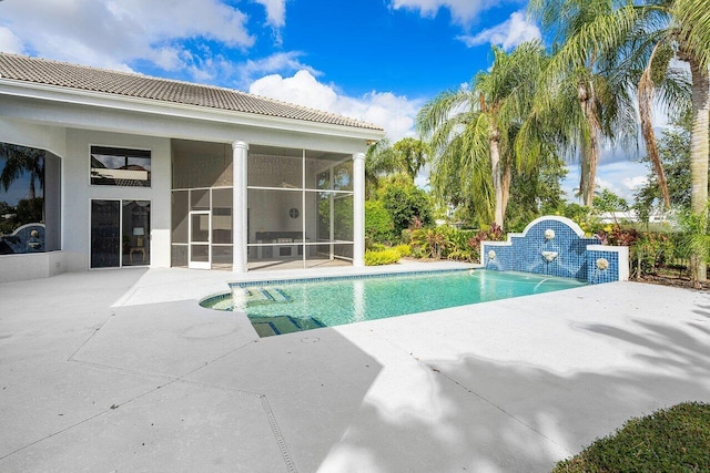 view of pool featuring a sunroom and a patio