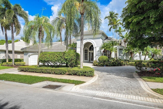 mediterranean / spanish home with a garage